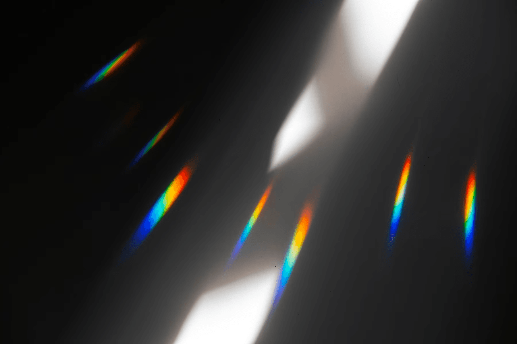 A sheet of bent glass bending and splitting the light passing through it.